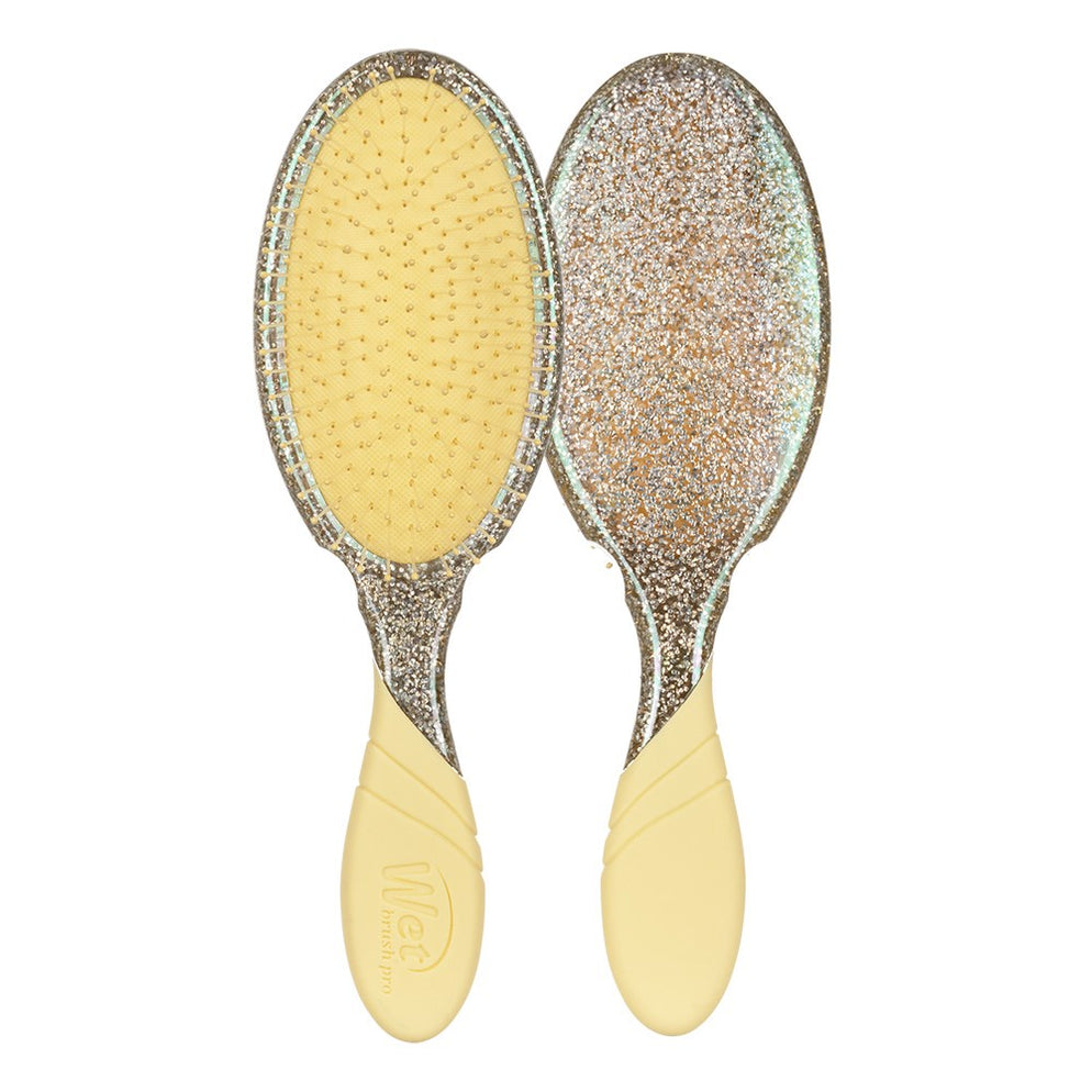 Two glittery hairbrushes with yellow handles on a white background