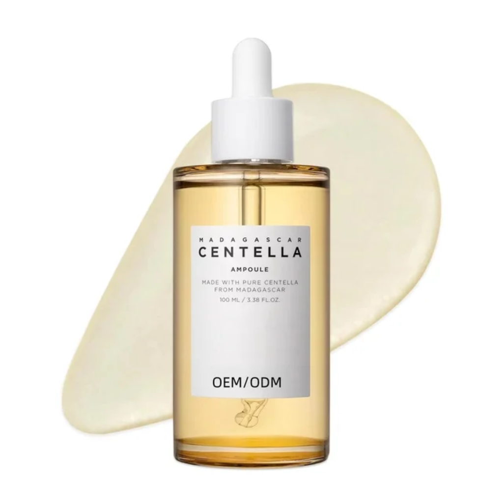 A 100 ml bottle of Madagascar Centella Ampoule serum with a white dropper cap, showcasing golden-yellow liquid inside a clear bottle, set against a white background with a soft cream-colored circular texture swatch behind it.