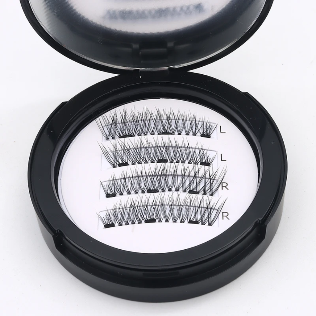 Open black circular case displaying three pairs of black false eyelashes on a white insert labeled L and R, on a white background.