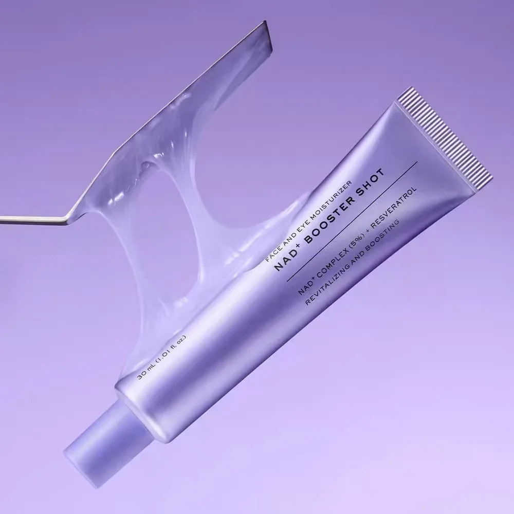 A tube of hair care product labeled 'NAD+ BOOSTER SHOT' floating diagonally against a soft lavender background, with a translucent stylized droplet graphic behind it.