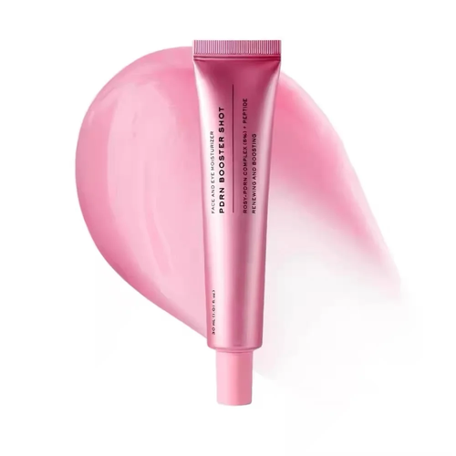 Pink squeeze tube of PORN BOOSTER SHOT cosmetic product centered over a soft pink smear on a white background.