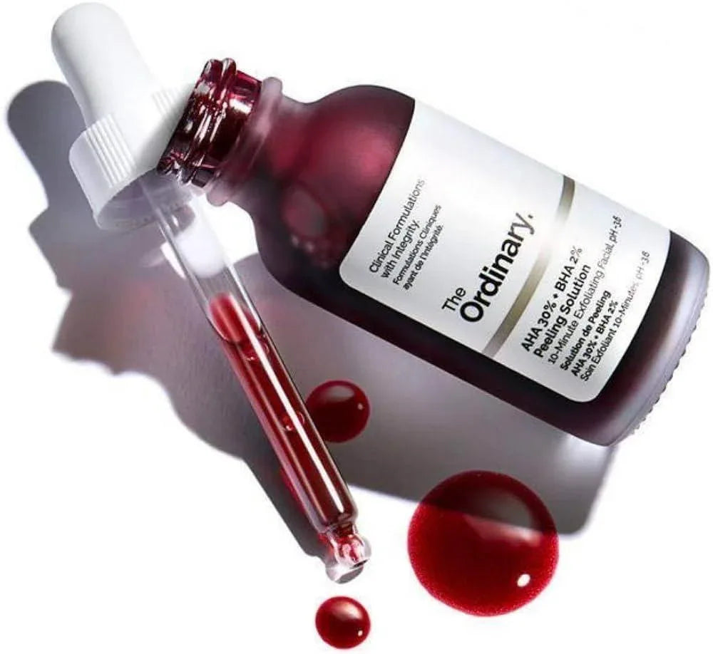 The Ordinary skincare serum bottle with dropper and red liquid on a white background