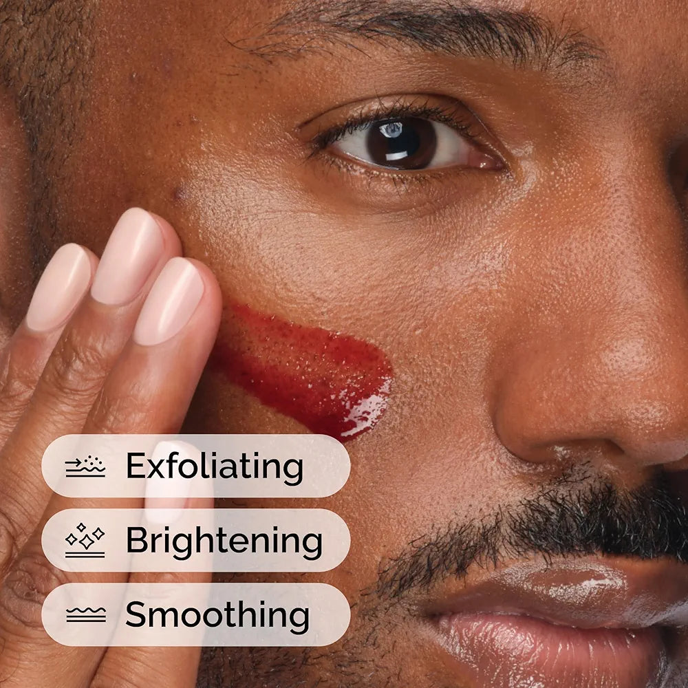 Close-up of a man's face with exfoliating, brightening, and smoothing text overlay.